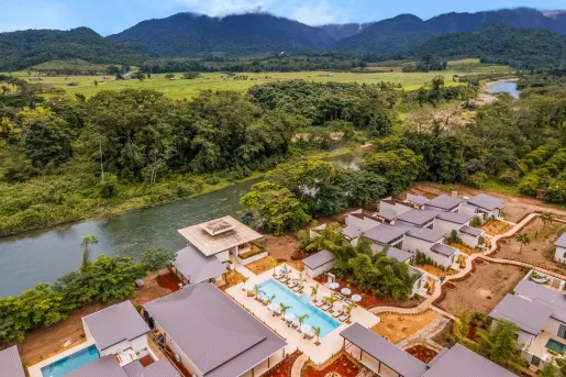 Sky view of hotel buildings with a river in the middle of a large valley