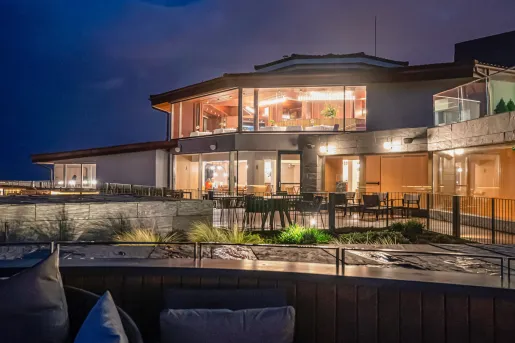 Nighttime exterior view illuminated building with large windows