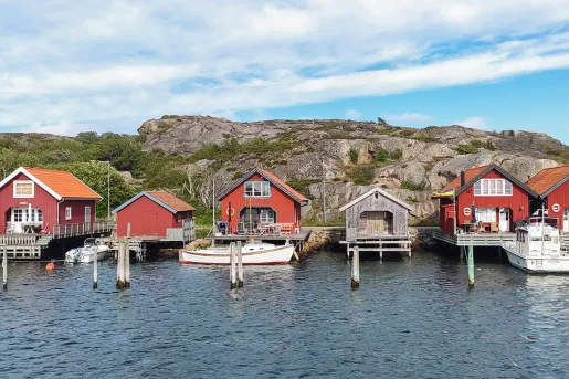 Row of red shacks on a dock by the water
