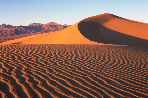 Sand dunes with mountains in the distance