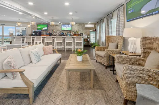 Bar and lounge with cushioned chairs with a bar counter in the back