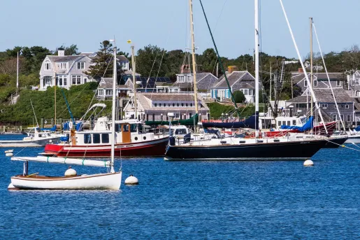 Cluster of boats floating in the water by a dock