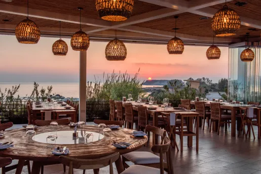 Outdoor patio with dining tables and woven light fixtures