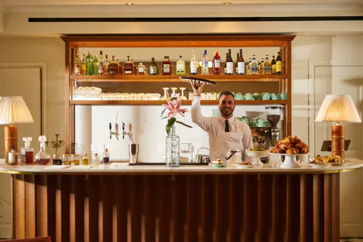 Bar and lounge with a bartender holding up a tray