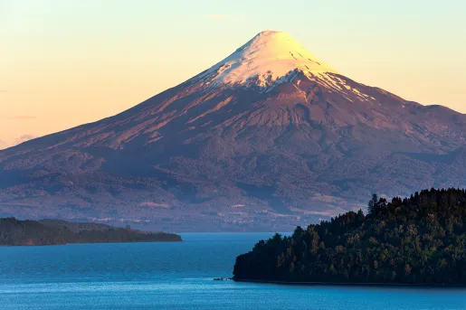 Snow-capped mountain behind a large lake