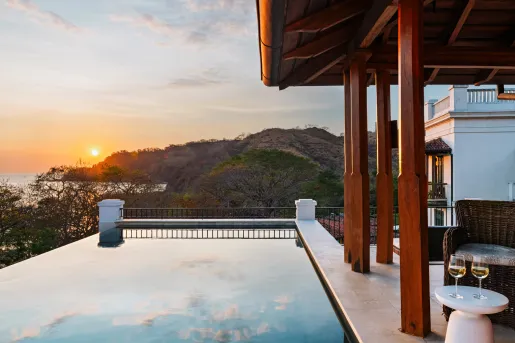 Outdoor pool with mountains and the ocean in the distance