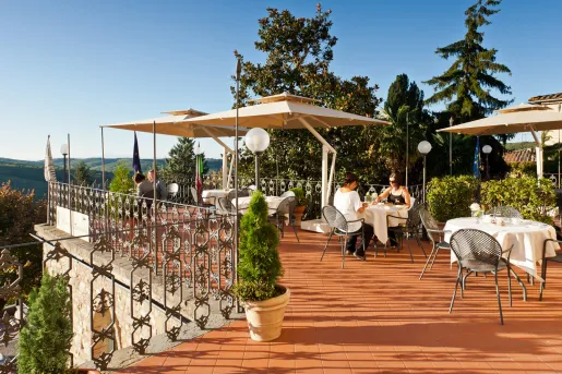 Rooftop patio and dining area, with two women dining at one of the tables