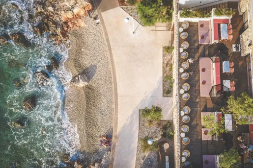 Top view of an outdoor patio, with the beach in front