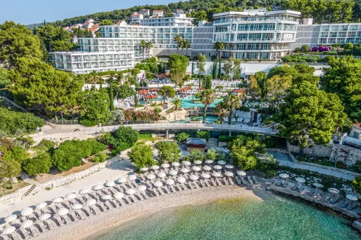 Exterior view of hotel complex with an outdoor pool and the beach on the ground level