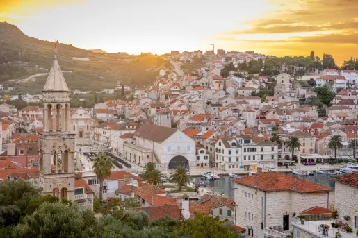 Town with red and beige buildings with a large church tower in the center