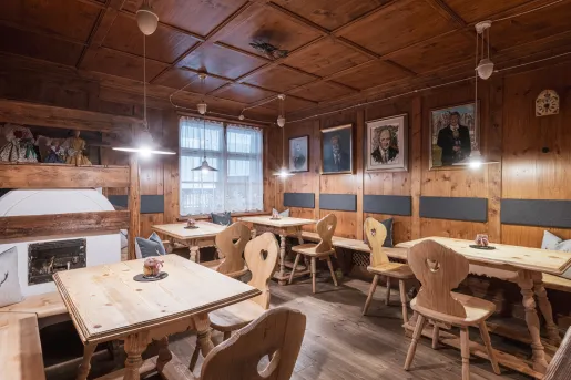Restaurant dining area with wooden tables and chairs, in a cabin style building