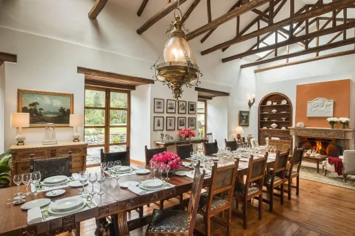 Dining area with a long wooden table and wooden chairs surrounding the table
