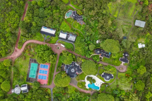 Sky view of hotel complex in the middle of a grassy valley