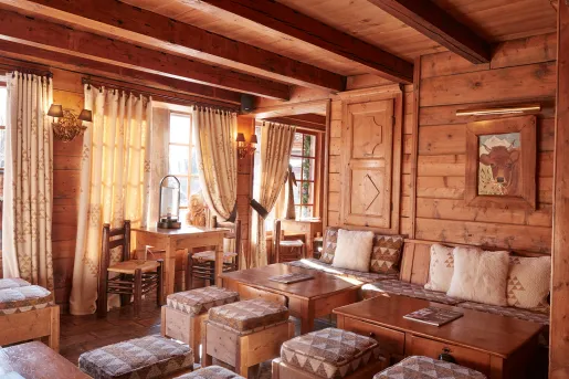 Indoor lounge and seating area inside of a wooden cabin