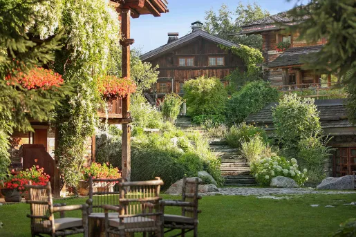 Outdoor garden and grass area with a wooden lodge in the background