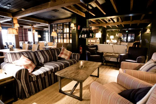 Cafe with cushioned sofas and tables in the background