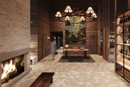 Hotel lounge with a wine rack to the right, and a fireplace and bench to the left