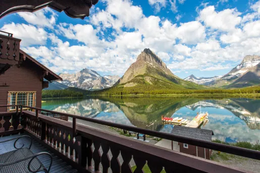 Outdoor balcony with a large lake and mountains in front