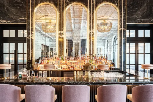 Bar with a marble countertop and alcohol on the shelves