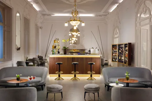 Bar and lounge with gray sofas and black bar stools