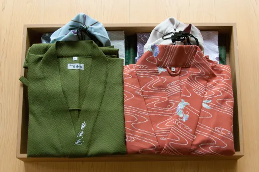 Wooden box filled with a folded green and pink kimono