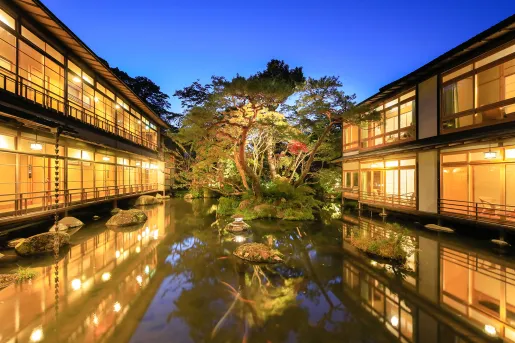 Exterior view of a small pong in front of a Japanese-style hotel building