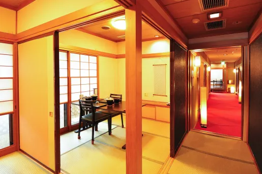 Room with tatami mats, and a dining tables with chairs surrounding it