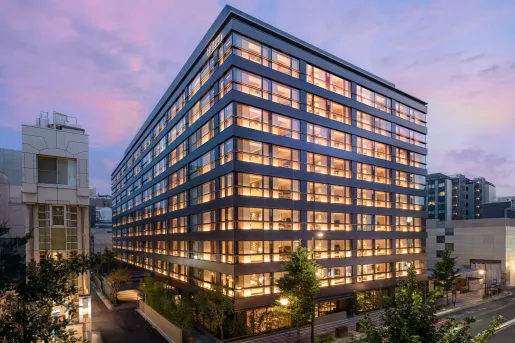 Exterior view of hotel building with illuminated rooms