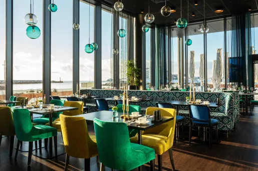 Dining area with large windows and circular light fixtures