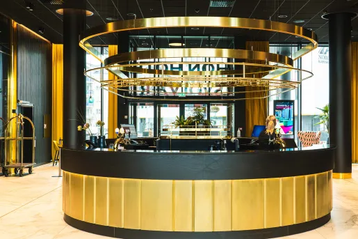 Hotel lobby with a black and gold circular check-in desk