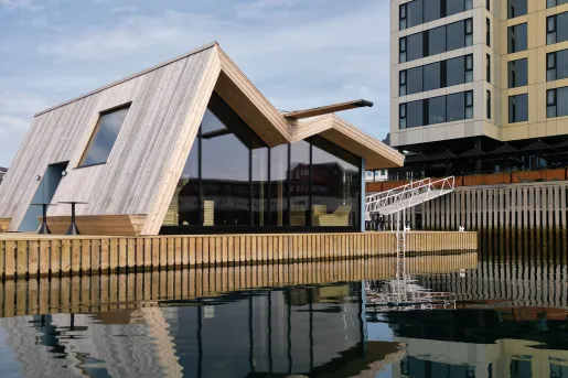 Building with artistic look in front of a lake