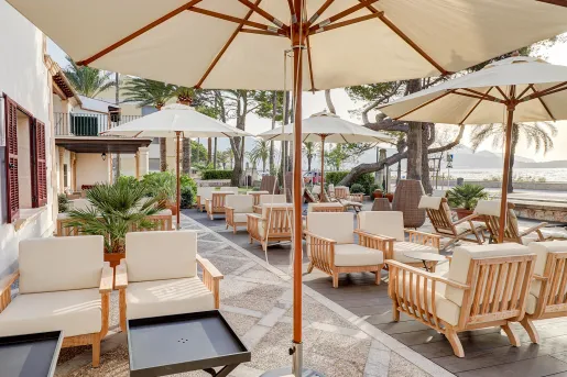 Outdoor patio with white umbrellas and cushioned chairs