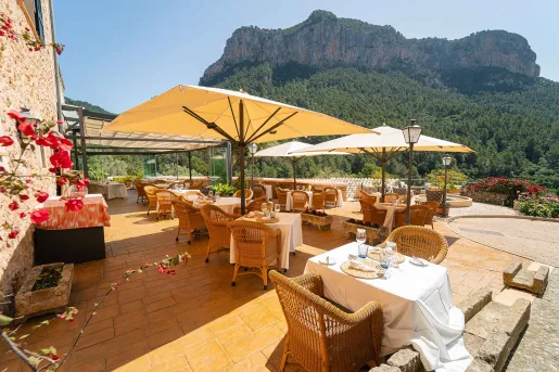 Outdoor dining patio with a view of a large mountain