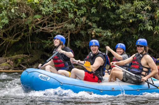 Three Backroads guests whitewater rafting