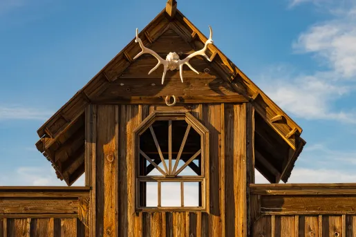 Wooden building with dried antlers hanging from the front