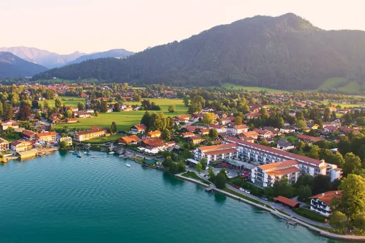 Sky view of a small town with white and brown buildings, with a lake in the center