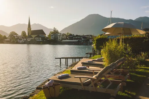 Reclining chairs in a row in front of a large lake
