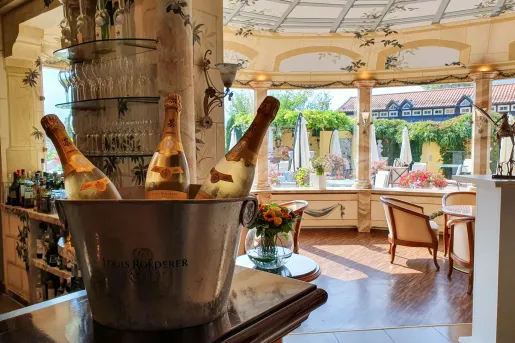 Bar and lounge with an ice bucket filled with three bottles of wine