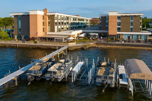 Large hotel complex in front of a dock full of boats