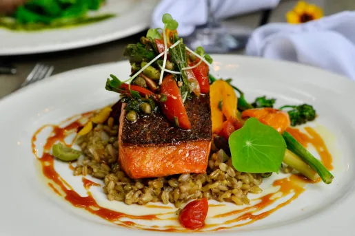 Plate of grilled fish on top of rice