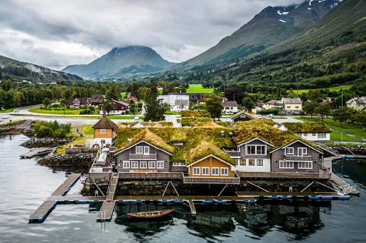 Exterior view of boat houses with large mountains in the background