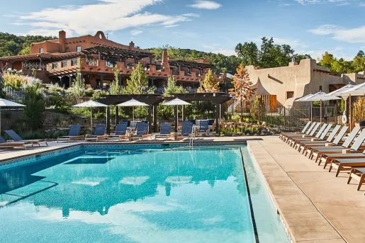Outdoor pool surrounded by gray, reclining chairs