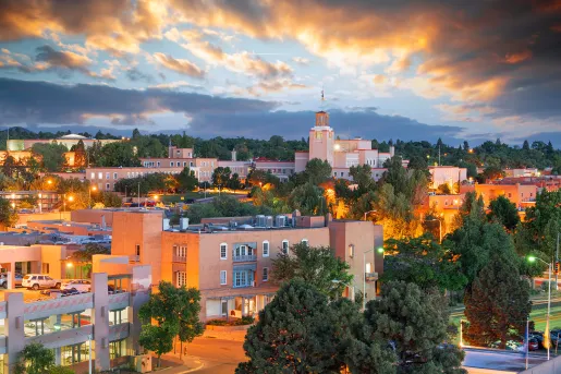 Town with building illuminated by orange lights