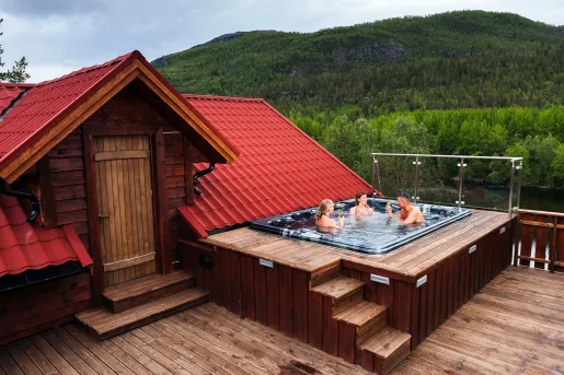 Rooftop with a hot tub and three people sitting inside