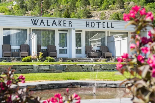 Exterior view of white building with a Walker Hotel sign