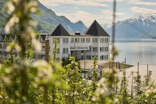 Castle-like white and brown building by a lakefront