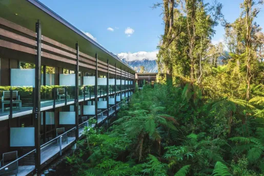 Exterior view of a multi-level building with balconies with glass barricades