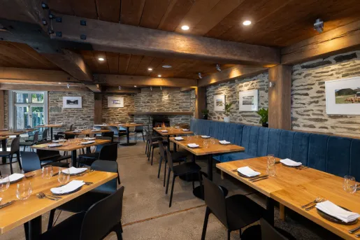 Restaurant with blue benches and wooden dining tables