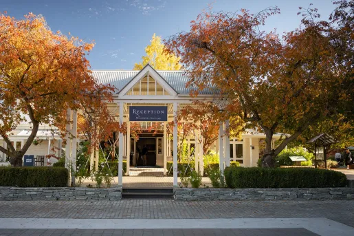 Exterior view of hotel reception building with a stone pathway