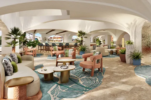 Bar and lounge with a bar counter in the back and cushioned chairs throughout the large room